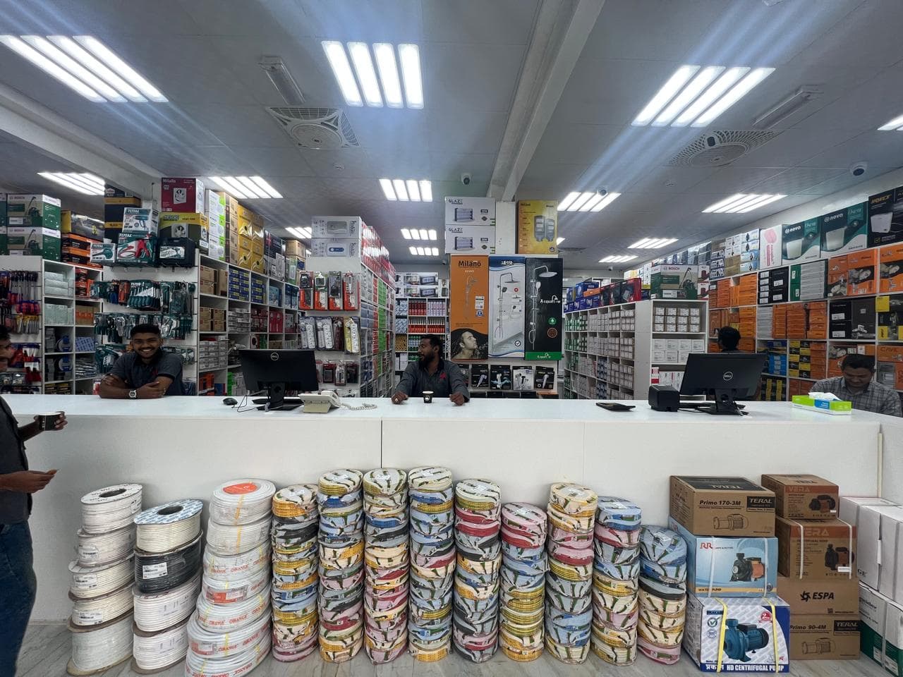 Stocked shelves and sales counter inside the AAR Trading shop in Ajman